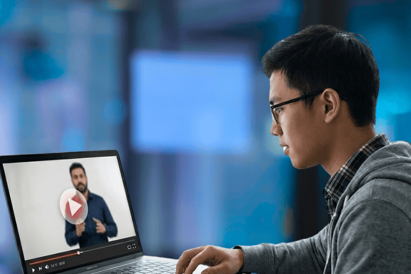 Individual learning digital marketing through recorded video lessons on laptop with flexible training